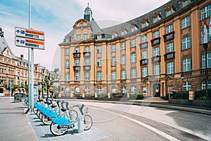 LUXEMBOURG. Row of city bikes for rent on a background of bank building