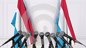 Luxembourgian official press conference. Flags of Luxembourg and microphones. Conceptual 3D animation