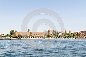 Luxor, Egypt: Panorama of river Nile in Luxor city, view from a boat. Residental buildings and sailboats