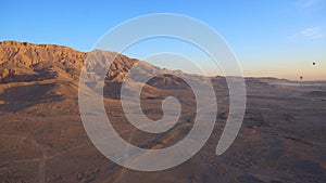 Luxor Egypt panorama view riding hot air balloon over valley of the king sunrise aerial view video