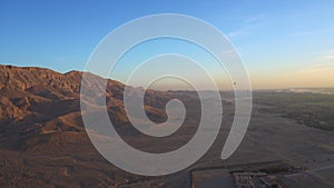 Luxor Egypt Riding hot air balloon over valley of the king sunrise aerial view video motion