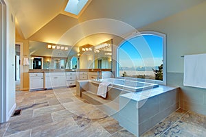 Luxuriant bathroom with whirlpool and amazing window view photo