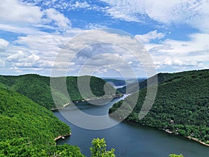 luxuriant landscape of a lake surrounded by virgin forest incredible aerial view in Romania Transylvania