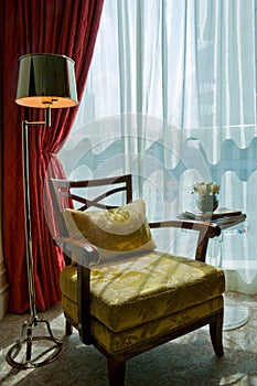 Luxurious armchair in the sun shine photo