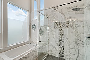 Luxurious bathroom with marble and sloped ceiling