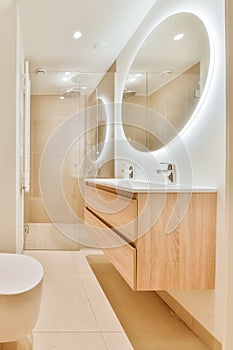 Luxurious bathroom with round large mirror with lighting