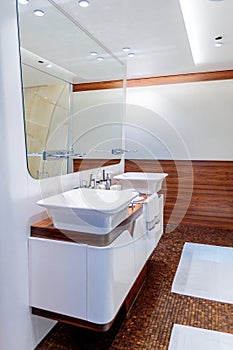 Luxurious bathroom with a white sink and a big mirror hung on the wall