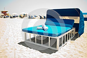 Luxurious beach bed with canopy on a sandy beach