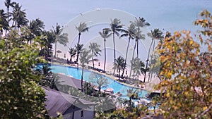 Luxurious beach resort with swimming pool. Summer island relax travel and idyllic vacation. Luxury tropical hotel resort