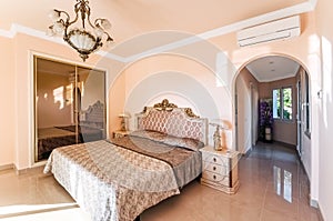 Luxurious bedroom with a large bed and a closet, with marble fl