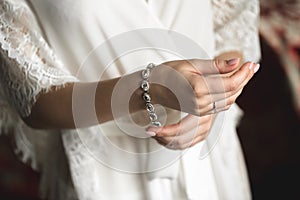 A luxurious bracelet on the bride& x27;s hand is a close-up of the bride& x27;s hand before the wedding.