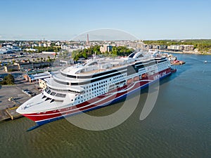 Luxurious cruise ship moored in a dock, its massive size creating an impressive scene