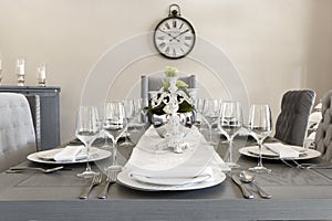 A luxurious dining room of a house with glasses and plates