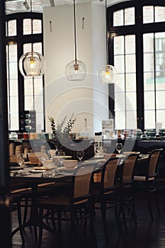 Luxurious dining room with multiple tables and chairs and  a large window