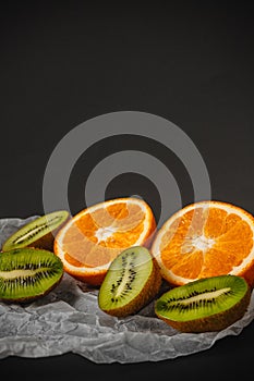 Luxurious fruit background.Orange and kiwi in a cut. Studio photography of various fruits isolated on black background