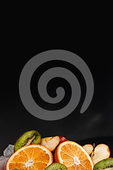 Luxurious fruit background.Orange and kiwi in a cut. Studio photography of various fruits isolated on black background