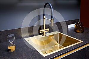 Luxurious interior square golden brass sink and faucet double tap mixer in contemporary modern design with stone marble