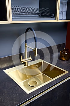 Luxurious interior square golden brass sink and faucet double tap mixer in contemporary modern design with stone marble