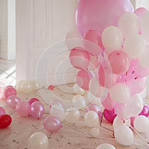Luxurious living room with large window to the floor. Palace is filled with pink balloons