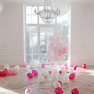 Luxurious living room with large window to the floor. Palace is filled with pink balloons