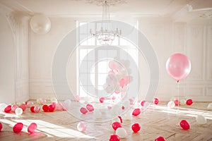 Luxurious living room with large window to the floor. Palace is filled with pink balloons