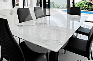 Luxurious marble dining table with black chairs