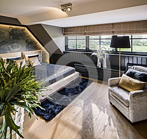 Luxurious master bedroom in black, blue and grey