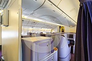 Luxurious and modern empty Interior in the airplane or passenger plane while parking view from rear