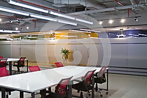 Conference room interior with empty chairs and a projector screen photo