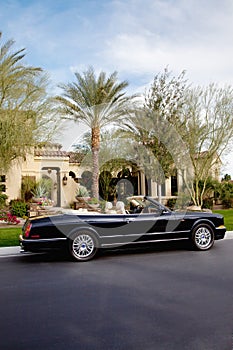 Luxurious open roof car parked outside villa