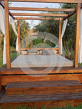 Luxurious pool side bed in tropical garden. Travel, holidays concept.