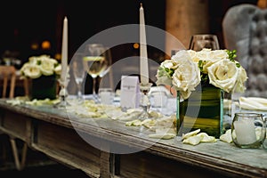 Luxurious romantic party table setting lit by candles, elegant ballroom for wedding reception, decoration ideas