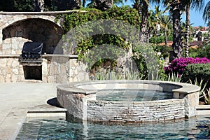 Luxurious spanish style pool jacuzzi hot with luxury water feature fountain at gorgeous villa with ocean view in Los Cabos Mexico