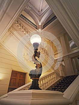 Luxurious stairwell with vintage lamp glowing in the hall of a 5 stars hotel