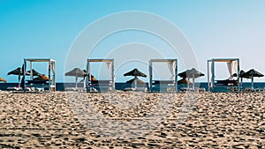 Luxurious sun loungers on the beach at Quarteira, Algarve, Portugal photo