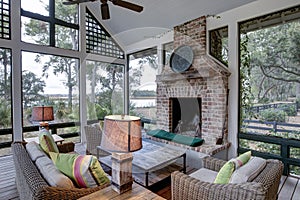 Luxurious three season screen porch with fireplace, looking out onto waterfront property photo