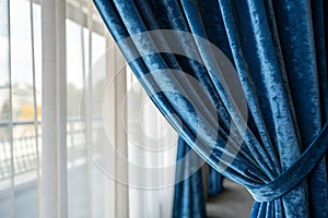 Luxurious velvet curtains in blue hue photo