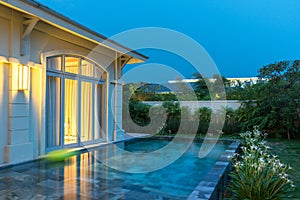 Luxurious villa with swimming pool in resort at twilight, luxury private expensive house