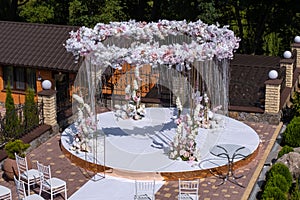 Luxurious wedding 3-dimensional circular arch for the newlyweds ceremony with chairs for guests