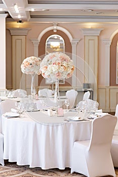Luxurious wedding decor at the dining tables in the restaurant `s bright hall