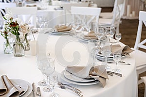 Luxurious wedding table decoration for reception of guests with stylish napkins, cute natural flower