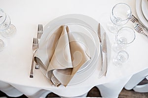 Luxurious wedding table decoration for reception of guests with stylish napkins, cute natural flower