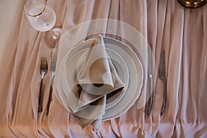 Luxurious wedding table decoration for reception of guests with stylish napkins, cute natural flower