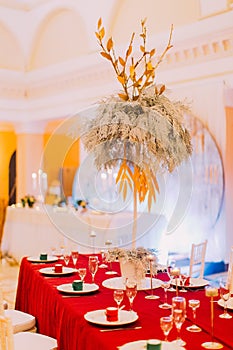 Luxurious wedding table with red tablecloth. Wedding celebration
