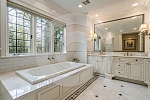 Expensive white bathroom with large rectangular bathtub