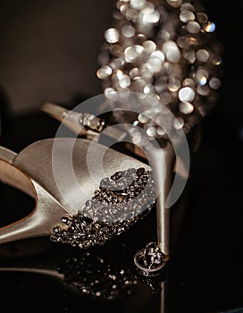 Luxurious White Gold Diamond Engagement Ring Next to Wedding Shoes Bride. Wedding Details