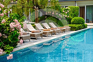 Luxury 5 star hotel pool in Asia with chairs
