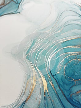 Luxury abstract fluid art painting background alcohol ink technique blue and gold. Marble texture