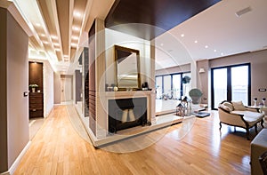 Luxury apartment interior with fireplace filed with candles