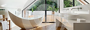 Luxury attic bathroom with bathtub, panorama